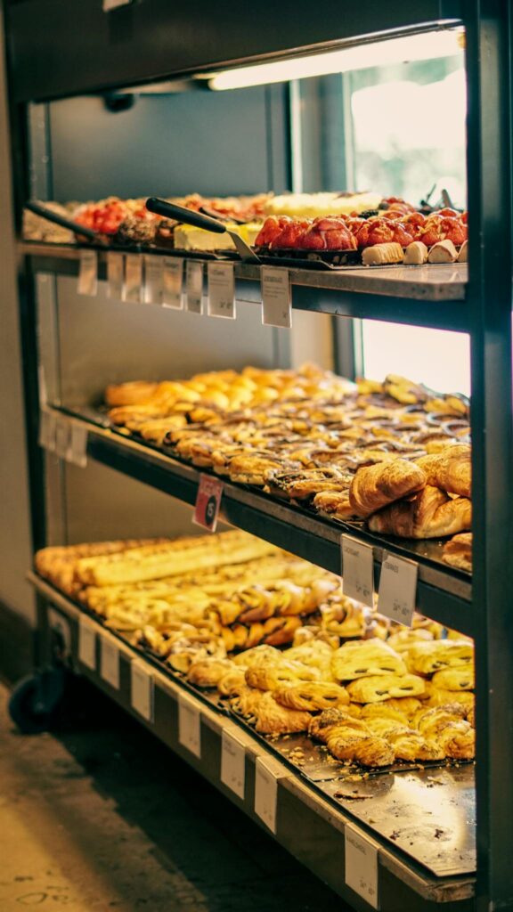 A vibrant display of assorted pastries and sweets on trays in a bakery, inviting with its delicious variety.